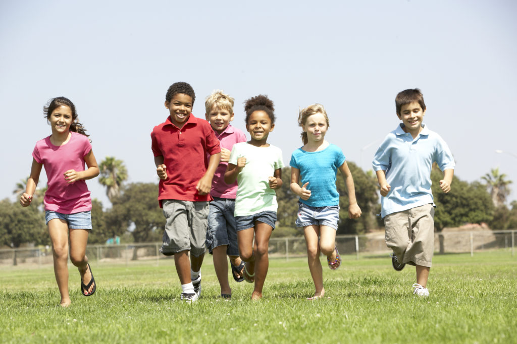 Group of kids running are examples of children that can benefit from ortho-tain instead of traditional braces.