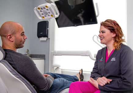 Nicole L. Hurcomb, DDS consults with a patient about gum disease treatment options at Tulip Tree Dental Care in South Bend, IN.