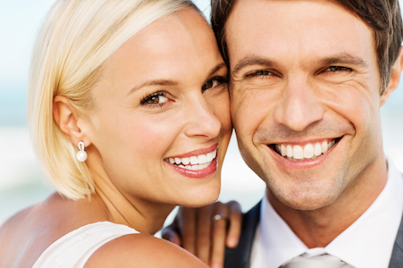 A young couple show off results from teeth whitening services at Tulip Tree Dental Care in South Bend, IN.